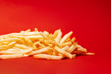 French fries on red background, potato chips close-up shot, side view, street food