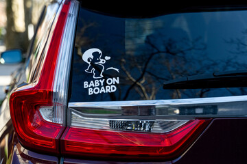 baby on board sign on car window