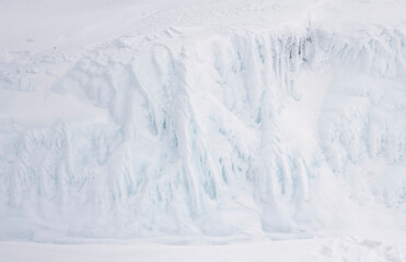 Fototapeta na wymiar Abstract white ice and snow background, snow covered cliff on lake Baikal.