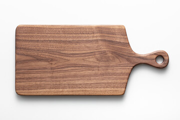 Handmade black walnut wood cutting board on white background. Handmade wooden chopping board.