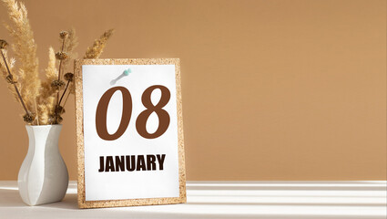 january 8. 8th day of month, calendar date.White vase with dead wood next to cork board with numbers. White-beige background with striped shadow. Concept of day of year, time planner, winter month