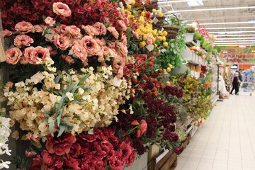 Russia, Novosibirsk 30.11.2021: a showcase with flowers in the greenhouse of a garden store with a buyer