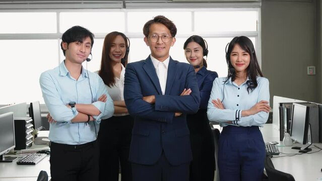 Businessman leader smiling in formal suit glasses standing smart with his arms crossed in an office workplace, portrait of happy young male boss manager or CEO look at camera