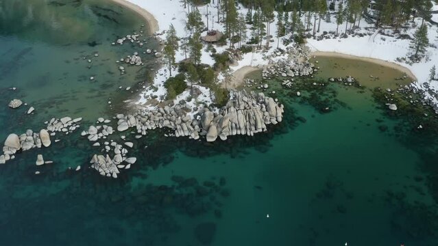 Aerial decent above Sand Harbor Lake Tahoe to the water line.