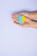 Support for Ukraine in the war with Russia, Hands holding symbol of Heart with flag of Ukraine. Pray, No war, stop war and  stand with Ukraine