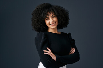 I love being a woman in business. Shot of a young businesswoman against a studio background.