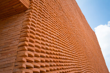 Red brick wall and ceiling background texture of the building with old dirty and vintage style pattern  that made from baked clay or earthenware with blue sky.