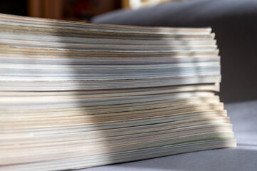 A stack of magazines against a gray background. Close-up of old print editions.