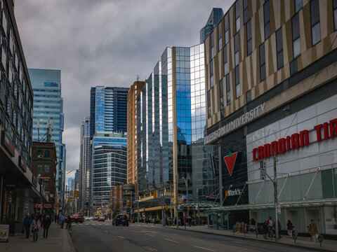 TORONTO, CANADA - MARCH  31 , 2022 : Bay Street and Dundas Street intersection in Downtown Toronto on a cloudy day