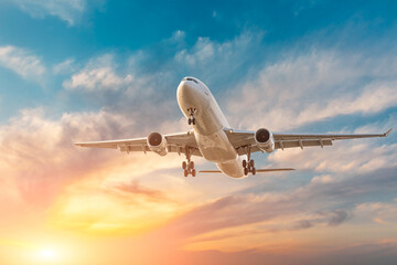Fototapeta na wymiar Airplane in the sunset sky. travel concept.