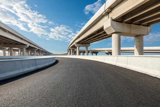 Fototapeta Asphalt highway and bridge under blue sky