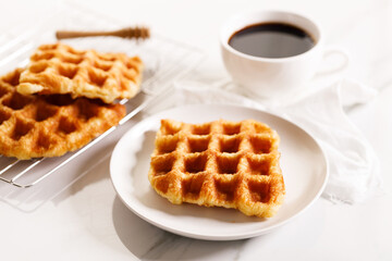 Croissant waffle or Croffle served in a white plate..