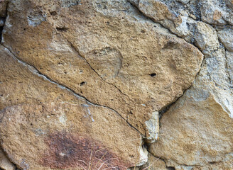 Natural mountain stone, the texture of the site, the walls of a stone canyon in a mountainous area.