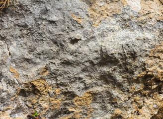 Natural mountain stone, the texture of the site, the walls of a stone canyon in a mountainous area.