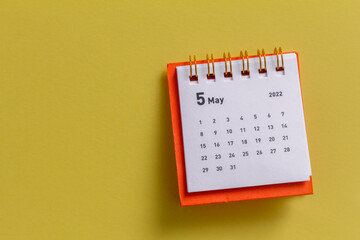 Desktop calendar for May 2022 for planning.Spring is in the yard.