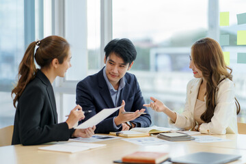 Group of Asian business people meeting working with new startup project idea presentation analyze plan marketing and investment.