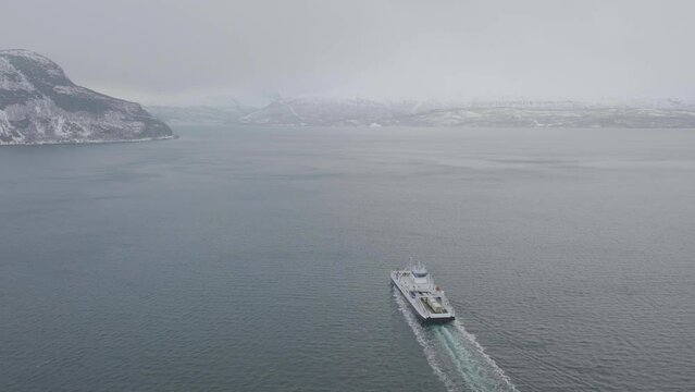 Aerial drone follows ferry from Olderdalen to Lyngseidet, Norway.