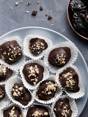 Vegan raw chocolate candies with dried plums and nuts