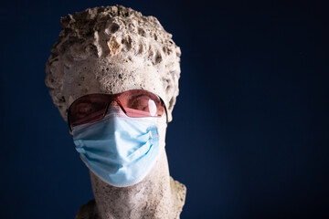 Ancient statue in medical mask