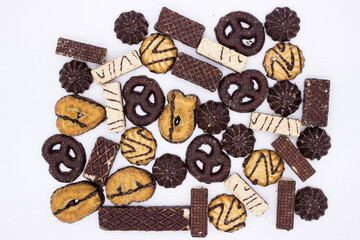 Chocolate biscuits and waffles on light background