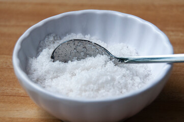 Close up of salt intake with spoon. Healthy food concept