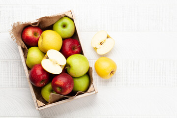Colorful ripe apple fruits in box