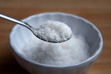 Close up of salt intake with spoon. Healthy food concept