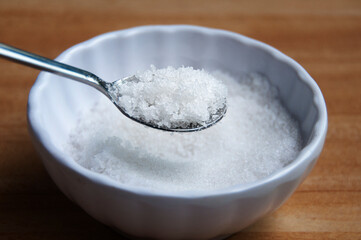 Close up of salt intake with spoon. Copy space concept