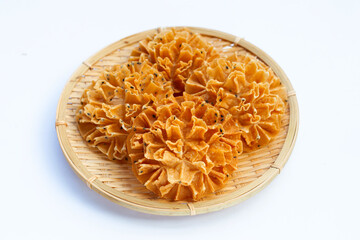 Crispy lotus blossom cookie on white background.