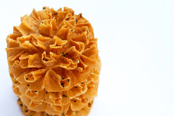Crispy lotus blossom cookie on white background.