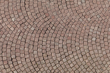 background of basalt cobble stone in red at the street