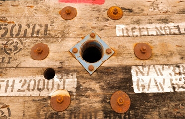 Retro old gray slat background with iron clad in planks and holes through the wood.