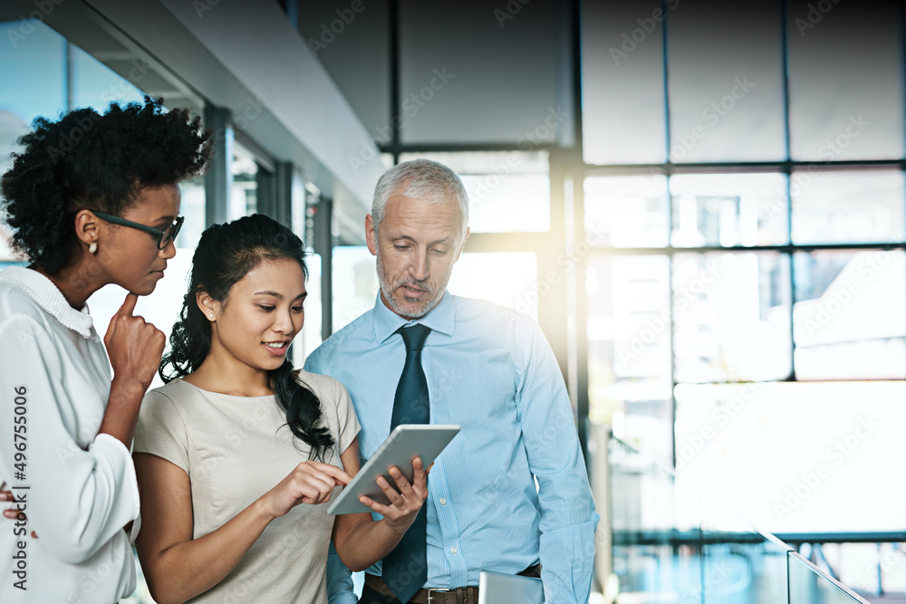 Aufkleber Using technology to take brainstorming to the next level. Shot of a business team using a digital tablet while having an informal meeting.