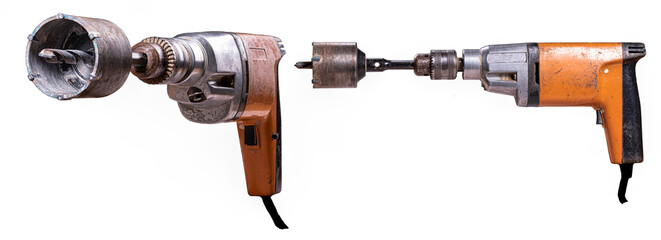 Old drill with mounted hole saw for concrete.