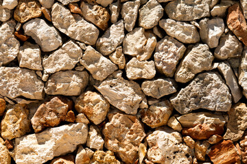 Brown rough sea stones on the coast, abstract background
