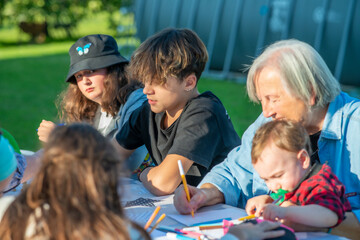 Grandparents and grandchildren playing together outdoor on a sun