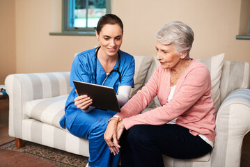 Let me show you our schedule for today. Shot of a female nurse showing her senior patient something...