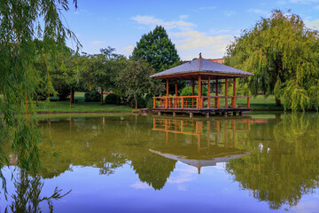 Obraz premium Pagoda and a pond in Yamaguchi Park, Pamplona, Spain famous for bull running