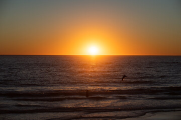 Fototapeta na wymiar Calm ocean water. Golden sunrise sunset over the sea waves. Sunrise over the ocean.