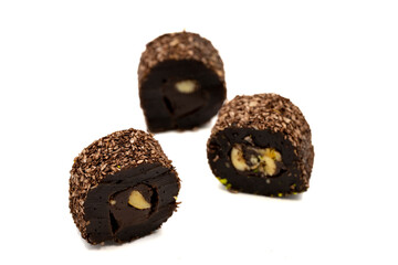 Turkish delight with hazelnut isolated on white background. Turkish delight with chocolate in the middle filled with hazelnut particles. close up