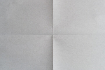Sheet of white paper folded into four parts, paper texture background