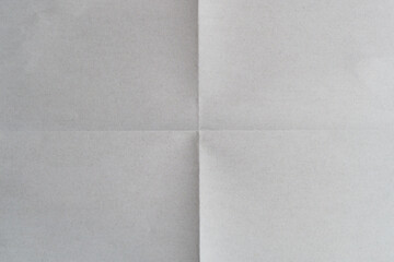 Sheet of white paper folded into four parts, paper texture background