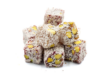 Turkish Delight with Pistachio isolated on a white background. Turkish Delight with Coconut Grain on it and Pistachio inside. Close-up. Traditional Turkish cuisine delicacies.
