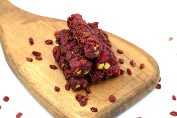 Turkish Delight Pistachio Pomegranate Fingers with Barberries isolated on a white background. Close-up pistachio Turkish delight. Traditional Turkish cuisine delicacies. Local name Zeresk lokum