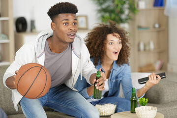 basketball fans watching the match on tv