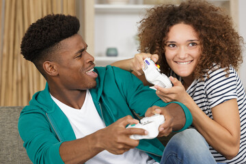 smiling couple playing video games