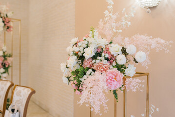 Beautiful floral arrangement of flowers in the decor of a wedding banquet in a restaurant