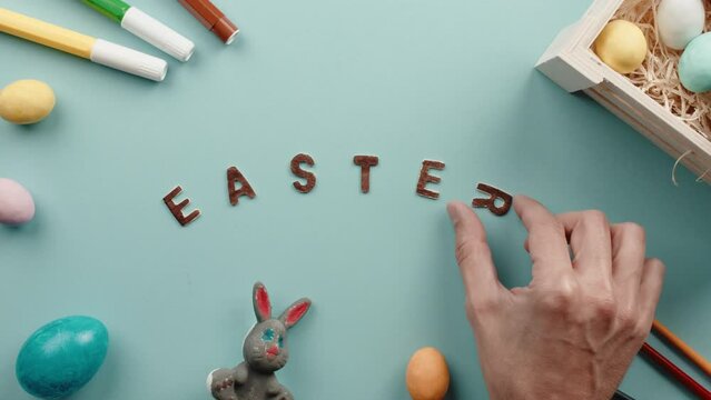 Easter text on a blue background with colored eggs