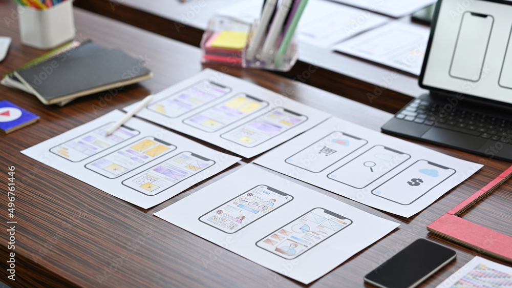 Poster creative designer workplace with digital tablet and wireframe sketches for mobile application on woo