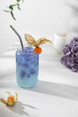 Obraz na płótnie Canvas Butterfly iced tea with coconut milk on the white table